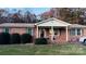 Charming brick home with covered porch and manicured landscaping at 124 Riley Rd, Dallas, NC 28034