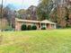 Lovely brick ranch-style house with a well-maintained front lawn and lush landscaping at 124 Riley Rd, Dallas, NC 28034