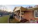 This cozy brick home has a covered front porch with white columns and trim at 124 Riley Rd, Dallas, NC 28034
