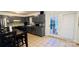 The kitchen features gray cabinets, stainless appliances, a tile backsplash, and backyard access at 124 Riley Rd, Dallas, NC 28034