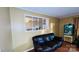 Cozy living room with a comfortable leather sofa and a unique pass-through window at 124 Riley Rd, Dallas, NC 28034