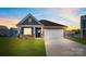 Charming single-story home boasts stone accents, inviting front porch, and well-manicured lawn at 1324 Secrest Commons Dr, Monroe, NC 28112