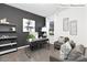 Stylish home office space with a large window, modern desk, and comfortable seating area at 1324 Secrest Commons Dr, Monroe, NC 28112