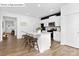 Stylish kitchen with white cabinets, granite countertops, and seating at the island, open to the living areas at 1324 Secrest Commons Dr, Monroe, NC 28112