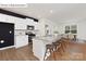 Modern kitchen featuring white cabinets, granite countertops, an island with seating, and stainless steel appliances at 1324 Secrest Commons Dr, Monroe, NC 28112