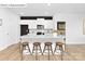 Modern kitchen featuring white cabinets, granite countertops, an island with seating, and stainless steel appliances at 1324 Secrest Commons Dr, Monroe, NC 28112