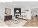 An inviting living room with a fireplace, and hardwood floors that flow into an open floor plan at 1324 Secrest Commons Dr, Monroe, NC 28112