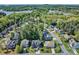An aerial view highlights a home nestled within a neighborhood surrounded by mature trees and serene lake views at 133 Misty Woods Dr, Lake Wylie, SC 29710