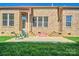 Brick home with a patio and lawn in the backyard, perfect for outdoor living and relaxation at 133 Misty Woods Dr, Lake Wylie, SC 29710