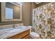 Cozy bathroom with a granite countertop vanity and a shower with a floral shower curtain at 133 Misty Woods Dr, Lake Wylie, SC 29710