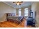 Comfortable bedroom featuring hardwood floors, natural light, and a ceiling fan at 133 Misty Woods Dr, Lake Wylie, SC 29710