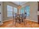 The dining area has beautiful hardwood floors and a stylish chandelier at 133 Misty Woods Dr, Lake Wylie, SC 29710