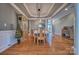 Elegant dining room with hardwood floors, a tray ceiling, and wainscoting at 133 Misty Woods Dr, Lake Wylie, SC 29710