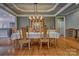 Formal dining room with stylish lighting, tray ceilings and plenty of space for gatherings at 133 Misty Woods Dr, Lake Wylie, SC 29710