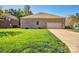Brick house featuring an attached two car garage and ample green space at 133 Misty Woods Dr, Lake Wylie, SC 29710