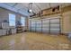 Spacious two-car garage with epoxy flooring, overhead storage, and abundant shelving providing organization and convenience at 133 Misty Woods Dr, Lake Wylie, SC 29710