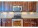 This kitchen includes stainless steel appliances and custom wood cabinetry at 133 Misty Woods Dr, Lake Wylie, SC 29710