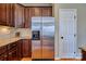This kitchen features wooden cabinets, granite countertops, and a stainless steel refrigerator at 133 Misty Woods Dr, Lake Wylie, SC 29710