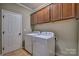 Functional laundry room with washer, dryer, and ample cabinet space at 133 Misty Woods Dr, Lake Wylie, SC 29710