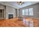 Spacious living room with a fireplace and large windows that let in natural light at 133 Misty Woods Dr, Lake Wylie, SC 29710