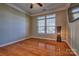 Bright living room featuring hardwood floors and a black modern floor lamp at 133 Misty Woods Dr, Lake Wylie, SC 29710