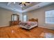 The spacious main bedroom has hardwood floors, large windows and recessed lighting at 133 Misty Woods Dr, Lake Wylie, SC 29710
