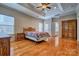 The main bedroom features hardwood floors, tray ceilings and large windows at 133 Misty Woods Dr, Lake Wylie, SC 29710