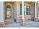 Inviting brick porch with classic columns and decorative shutters for enhanced curb appeal at 133 Misty Woods Dr, Lake Wylie, SC 29710