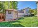 Backyard view showcases a wooden shed with double doors, enclosed by a black metal fence, offering ample storage at 133 Misty Woods Dr, Lake Wylie, SC 29710