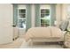 Bright bedroom featuring a bed with throw pillows, neutral decor, and light-filtering curtains at 1552 Croydon St, Indian Land, SC 29707
