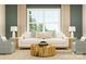 Inviting living room with a plush white sofa, blue accent pillows, and unique, round coffee table at 1552 Croydon St, Indian Land, SC 29707
