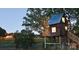 Quaint treehouse with a metal roof, wooden stairs, and nestled among lush greenery at 1619 Honey Trl, Monroe, NC 28112