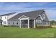 Charming home with a screened in porch and a lush, green lawn, perfect for outdoor enjoyment at 1619 Honey Trl, Monroe, NC 28112
