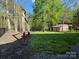 A backyard with a swing set, tire swing, small storage building, fenced in yard and green grass at 179 Tomahawk Ln, Mount Gilead, NC 27371