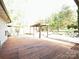 Large wooden deck and pergola in a backyard surrounded by lush greenery at 179 Tomahawk Ln, Mount Gilead, NC 27371