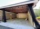 Open carport providing covered parking, with a durable concrete floor at 179 Tomahawk Ln, Mount Gilead, NC 27371