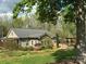 Charming single-story home with metal roof, landscaped yard, and inviting outdoor deck perfect for relaxing at 179 Tomahawk Ln, Mount Gilead, NC 27371