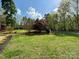 Expansive front yard featuring lush greenery and mature trees on a sunny day at 179 Tomahawk Ln, Mount Gilead, NC 27371