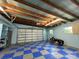 Well-lit garage features blue-and-white checkered floors and ample storage space at 179 Tomahawk Ln, Mount Gilead, NC 27371