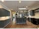 Stylish kitchen with gray cabinets, stainless steel appliances, center island, and subway tile backsplash at 179 Tomahawk Ln, Mount Gilead, NC 27371