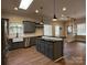 Bright and airy kitchen featuring stainless steel appliances, modern sink, and convenient center island with seating at 179 Tomahawk Ln, Mount Gilead, NC 27371