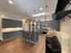 Well-lit kitchen with stainless steel appliances, center island, and abundant storage, perfect for culinary enthusiasts at 179 Tomahawk Ln, Mount Gilead, NC 27371