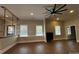 Open-concept living room with wood floors, large windows, and custom shelving, perfect for entertaining at 179 Tomahawk Ln, Mount Gilead, NC 27371