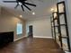 Spacious living room with modern light fixtures, wood-style accent wall, and custom shelving, ideal for relaxing at 179 Tomahawk Ln, Mount Gilead, NC 27371
