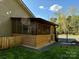 Enclosed screened porch with wood siding and view of the fenced backyard at 179 Tomahawk Ln, Mount Gilead, NC 27371
