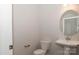 Half bathroom featuring a pedestal sink, oval mirror, and toilet at 184 Swann Rd # 1, Statesville, NC 28625