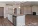 Open kitchen view featuring a granite island, stainless steel appliances, and sleek white cabinetry at 184 Swann Rd # 1, Statesville, NC 28625