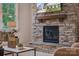 Stacked stone fireplace featuring a wood mantle is the focal point of this cozy and stylish living room at 2037 Mantle Ridge Dr, Indian Trail, NC 28079