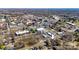 Aerial view of home in an urban setting surrounded by mature trees and buildings under a clear blue sky at 21 W D St, Newton, NC 28658