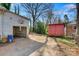 View of backyard with garage, shed, and trees on a sunny day at 21 W D St, Newton, NC 28658
